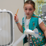 Girl Scout tests wind technology during Careers in Energy Week.